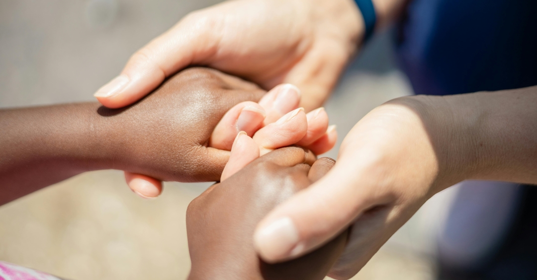 Two people hold hands